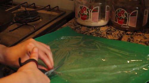 Close-Up View of a Person Cutting a Plastic