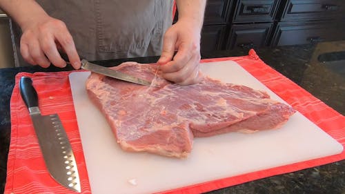 A Person Preparing a Raw Meat