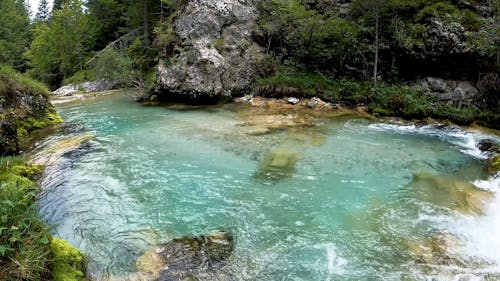 A River Flowing Through Rock Boulders 