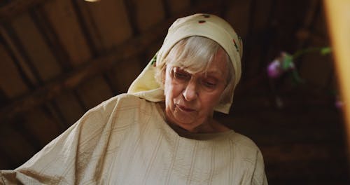 Low Angle Shot of an Elderly Woman in a Headscarf