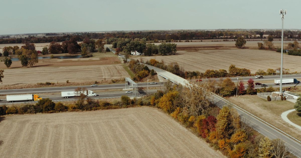 drone footage of vehicles traveling on roadway 5592467