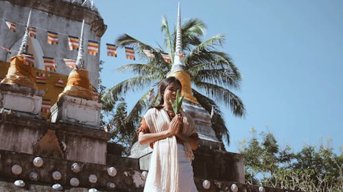 Buddhist Woman Praying Outdoors