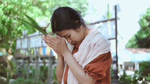 Buddhist Woman Praying Outdoors