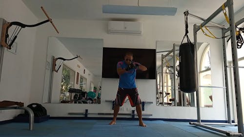 A Man Practicing His Punches Inside the Gym