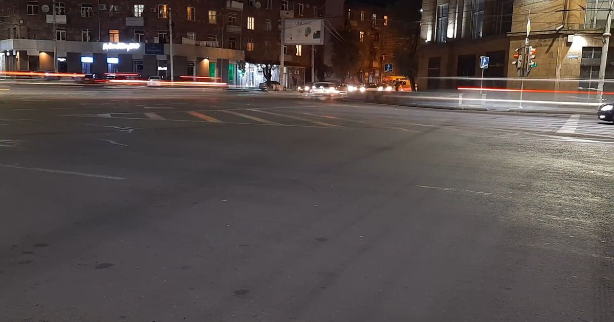 time lapse video of light trails passing by the road 5597175