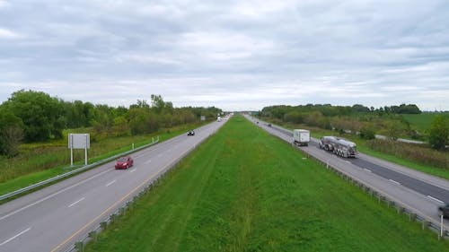 Vehicles Traveling on Expressway During Cloudy Day