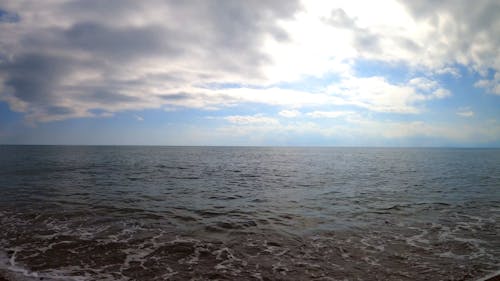 A Relaxing Scenery of Beach View Under Cloudy Sky