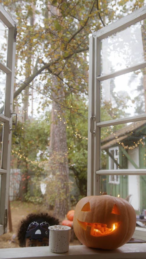 Playful Kid in Halloween Costume at the Window