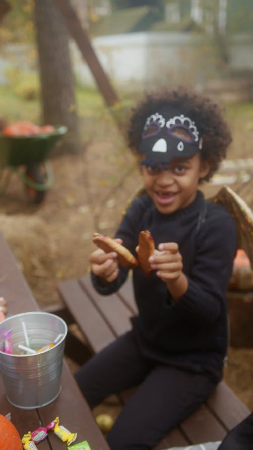 Kid Showing Halloween Cookies to the Camera