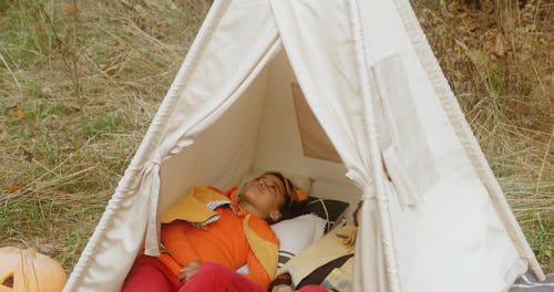 Children in Halloween Costume Laying in Tent 