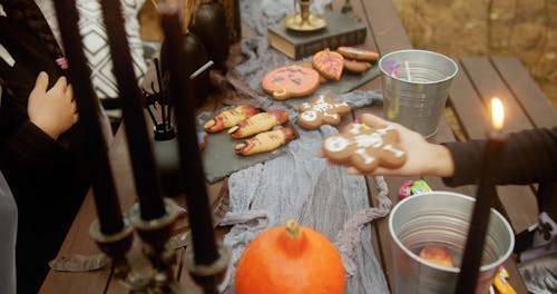 Kids Passing Halloween Cookies to Each Other