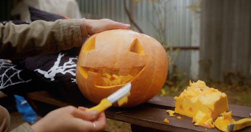 Woman Carving Halloween Pumpkin