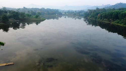 Drone Footage of a Placid Lake and Agricultural Lands