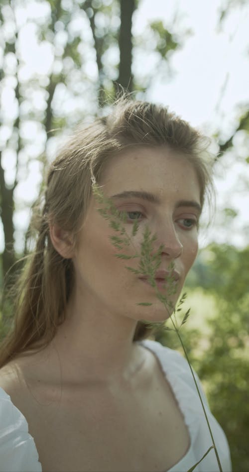 Close-Up View of Woman Holding a Herb