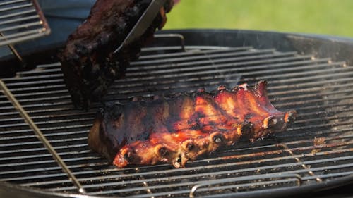 Person Cooking Food on a Grill