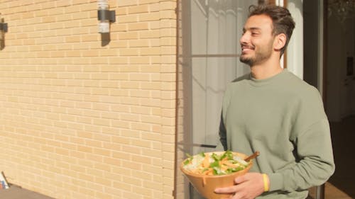 Man Getting Salad to the Dining Table