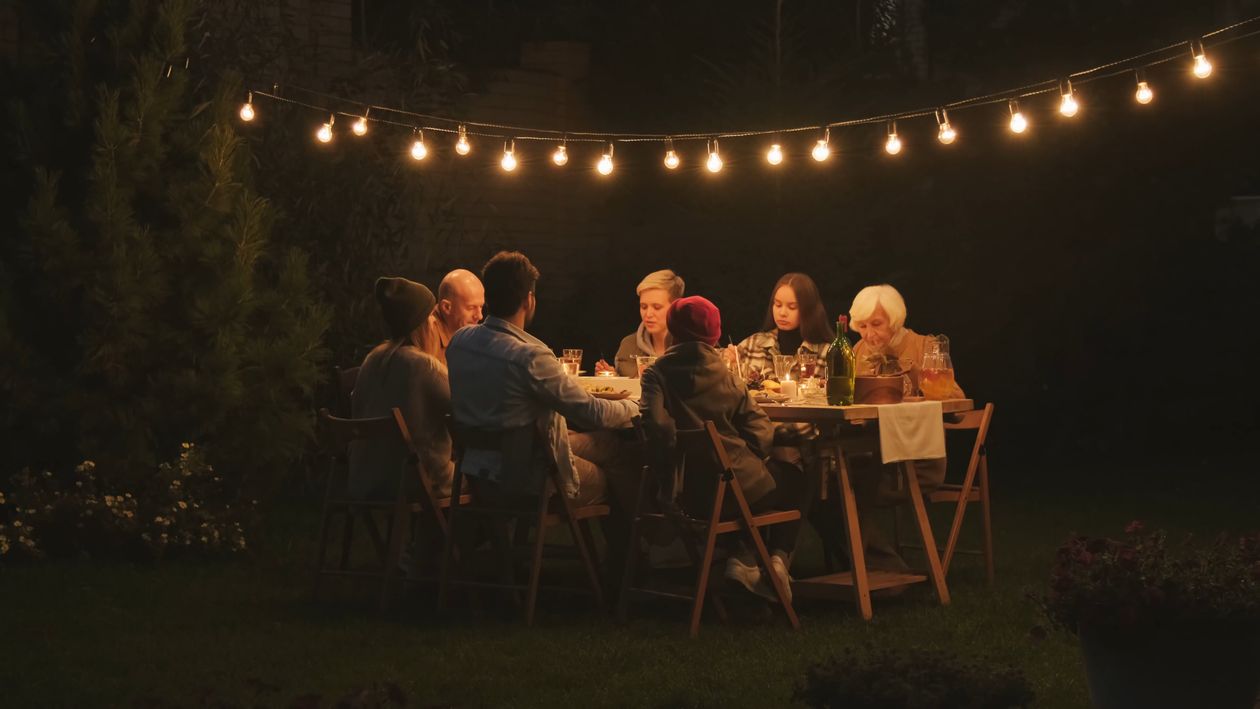 A family talking and laughing together around a table