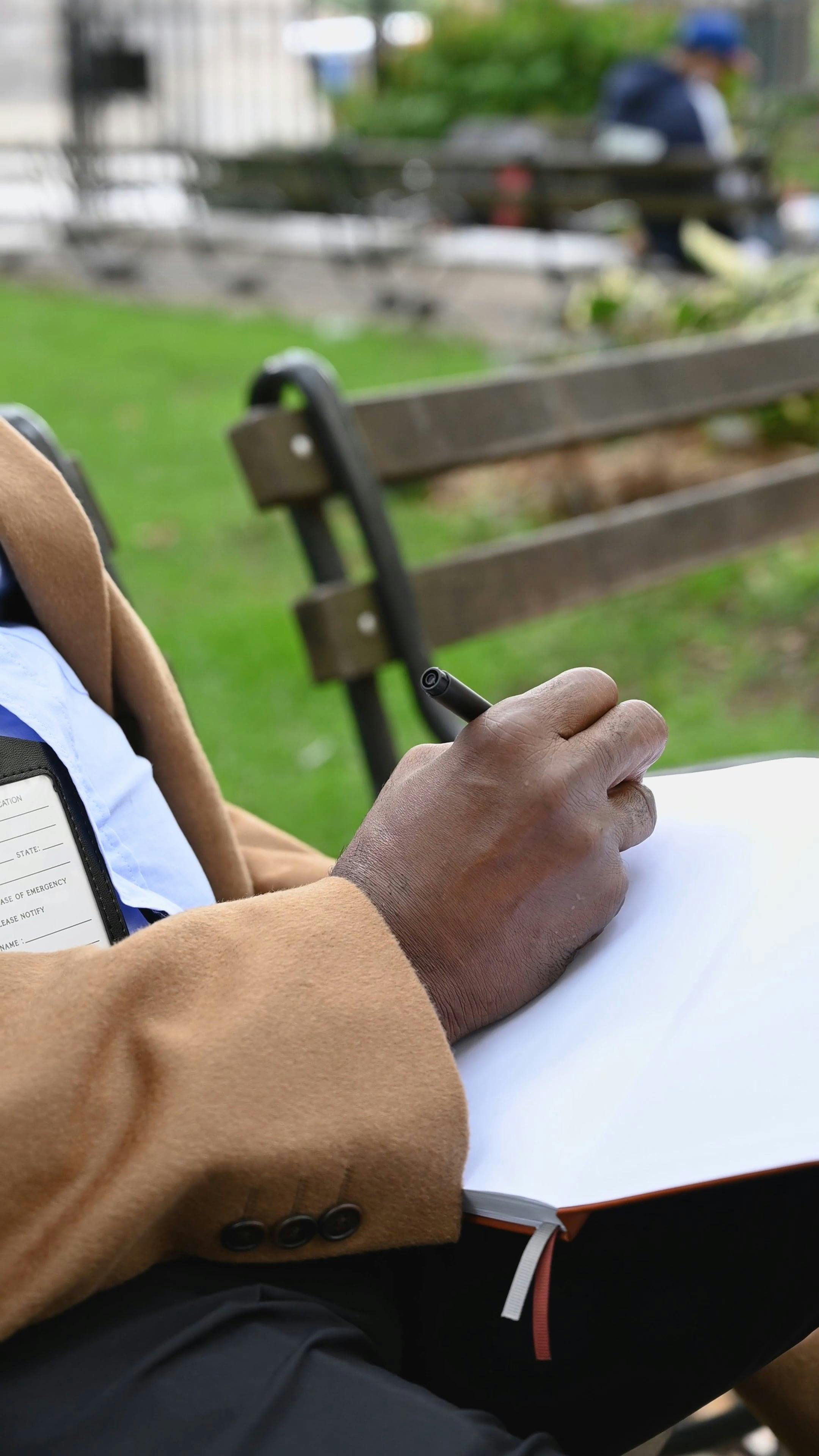 Person Writing On a Notebook · Free Stock Video