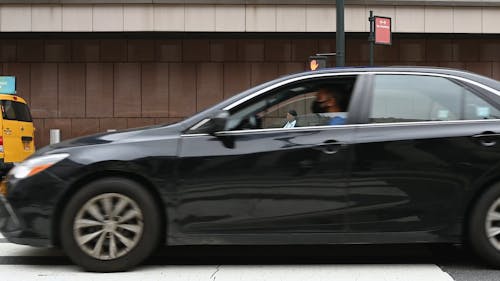 People Standing on a Pedestrian Lane