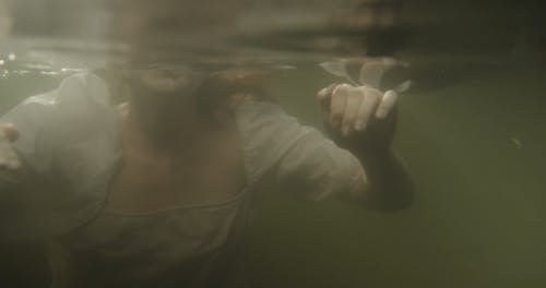 A Woman Swimming In A Lake