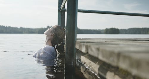 A Woman Dipping In A Lake