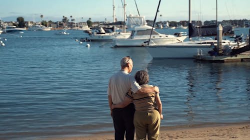 An Elderly Couple Enjoying The Sea Harbor View