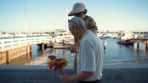 An Elderly Couple Walking By The Bay