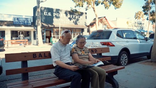 An Elderly Couple Reading The Newspaper