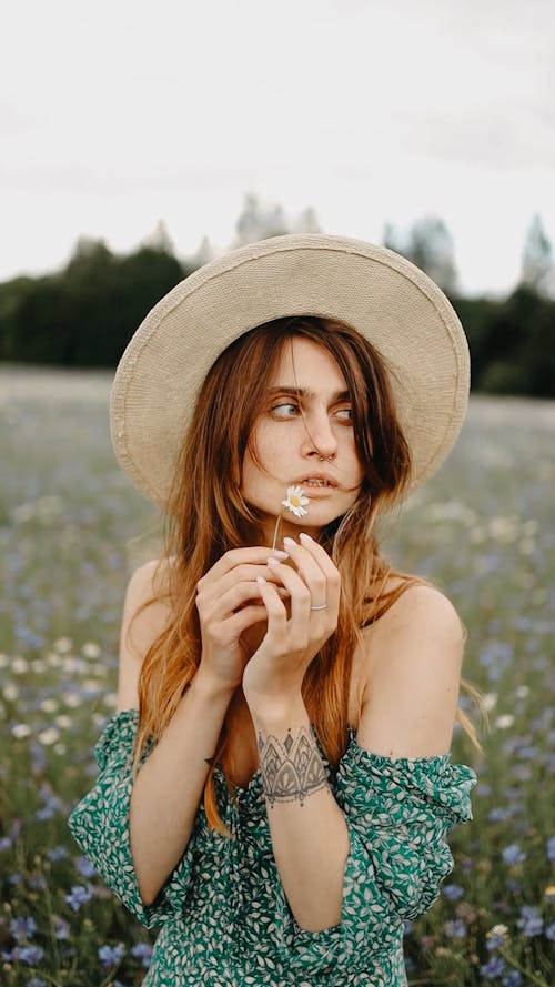 A Woman Standing In Th Flower Field