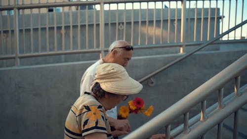 An Elderly Couple Climbing Stairs