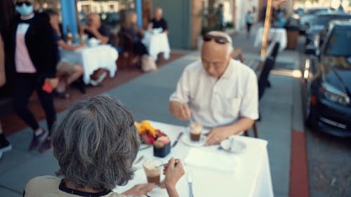 A Couple Eating In An Outdoor Restaurant