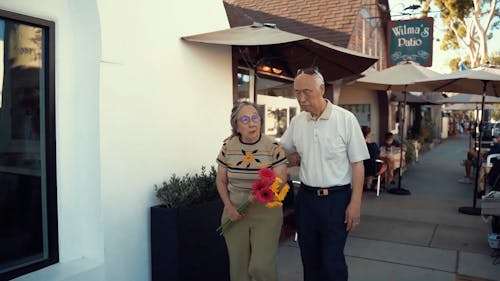 Elderly Couple Walking on the Street