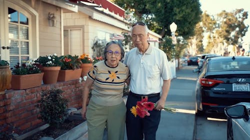 Elderly Couple Walking on the Street