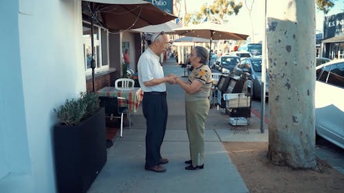 Elderly Couple Holding Hands on the Street