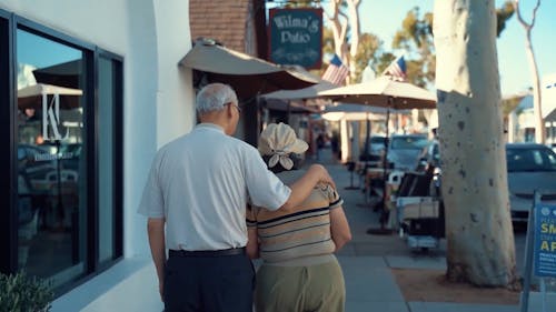 Elderly Couple Walking on the Street