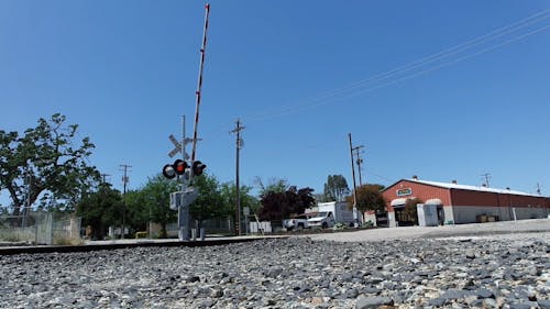 A Train Passing Through A Railroad Crossing