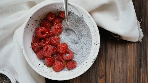 Close-Up View of Bowl of Raspberries With Chia Seeds and Milk