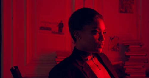 A Woman Looking Fiercely at the Camera Against Red Background Light