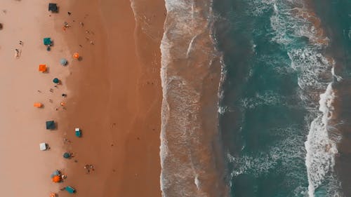 Top View of Ocean Waves Crashing on Beach Shore