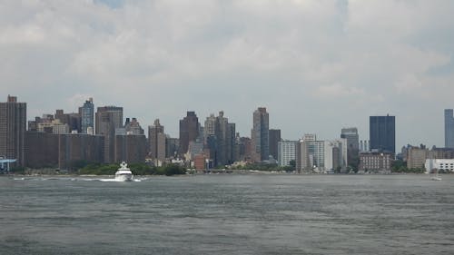 A White Yacht Traveling on a River and Passing Under the Bridge