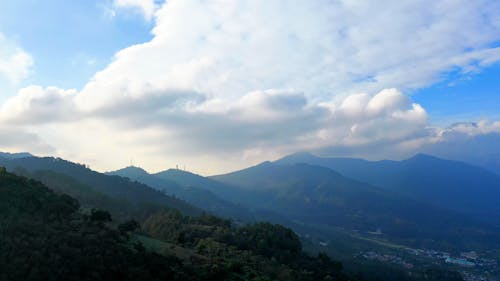 Landscape Scenery of Mountains Under White Clouds