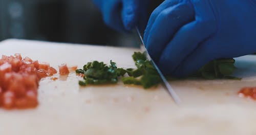 Close-Up View of a Person Cutting His Ingredients by Using a Knife