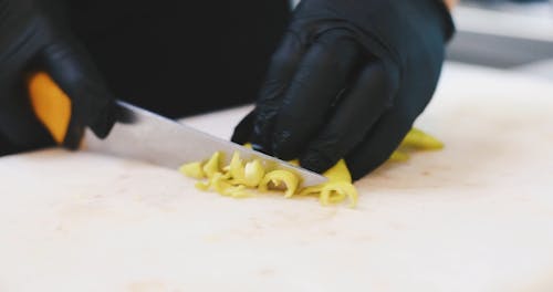 Close-Up View of a Person Slicing Up a Vegetable