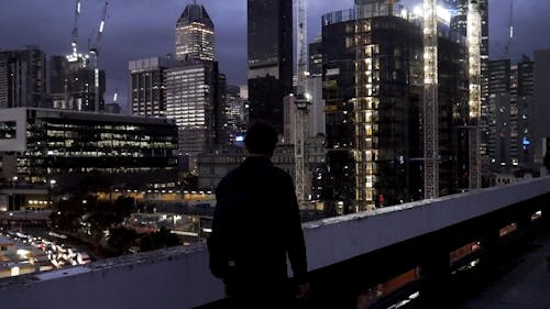 Man Looking at Night View of City