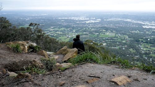 A Man Standing Over The Cliff Edge