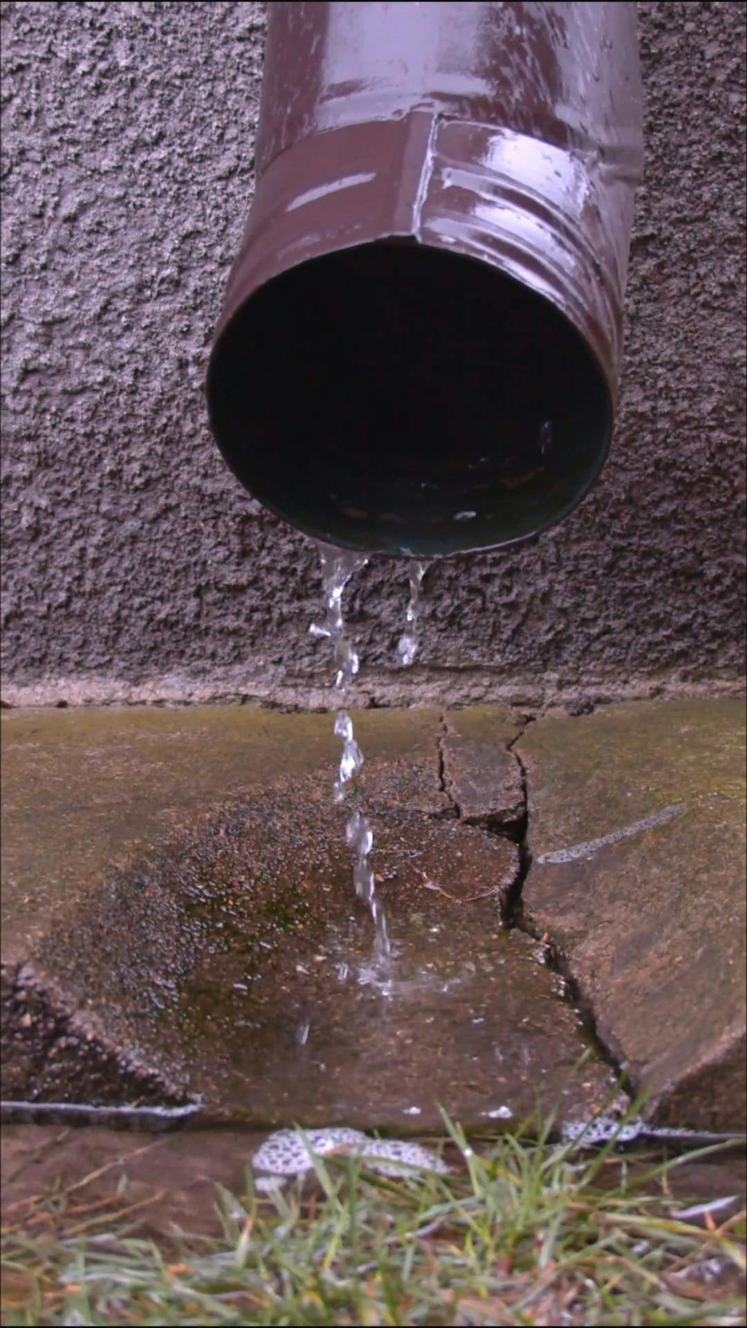 A Water Flowing Out of the Gutter · Free Stock Video