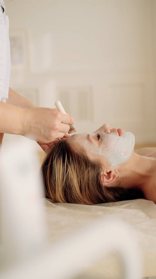 Woman Relaxing While Getting a Facial Treatment