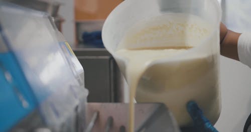 Pouring of Ice Cream Mix in the Machine