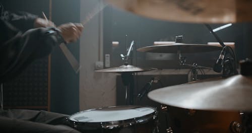 A Person Skillfully Playing His Drums