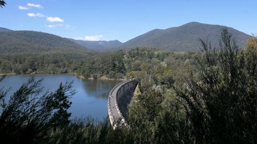 Aerial View of Dam with Mountain background 